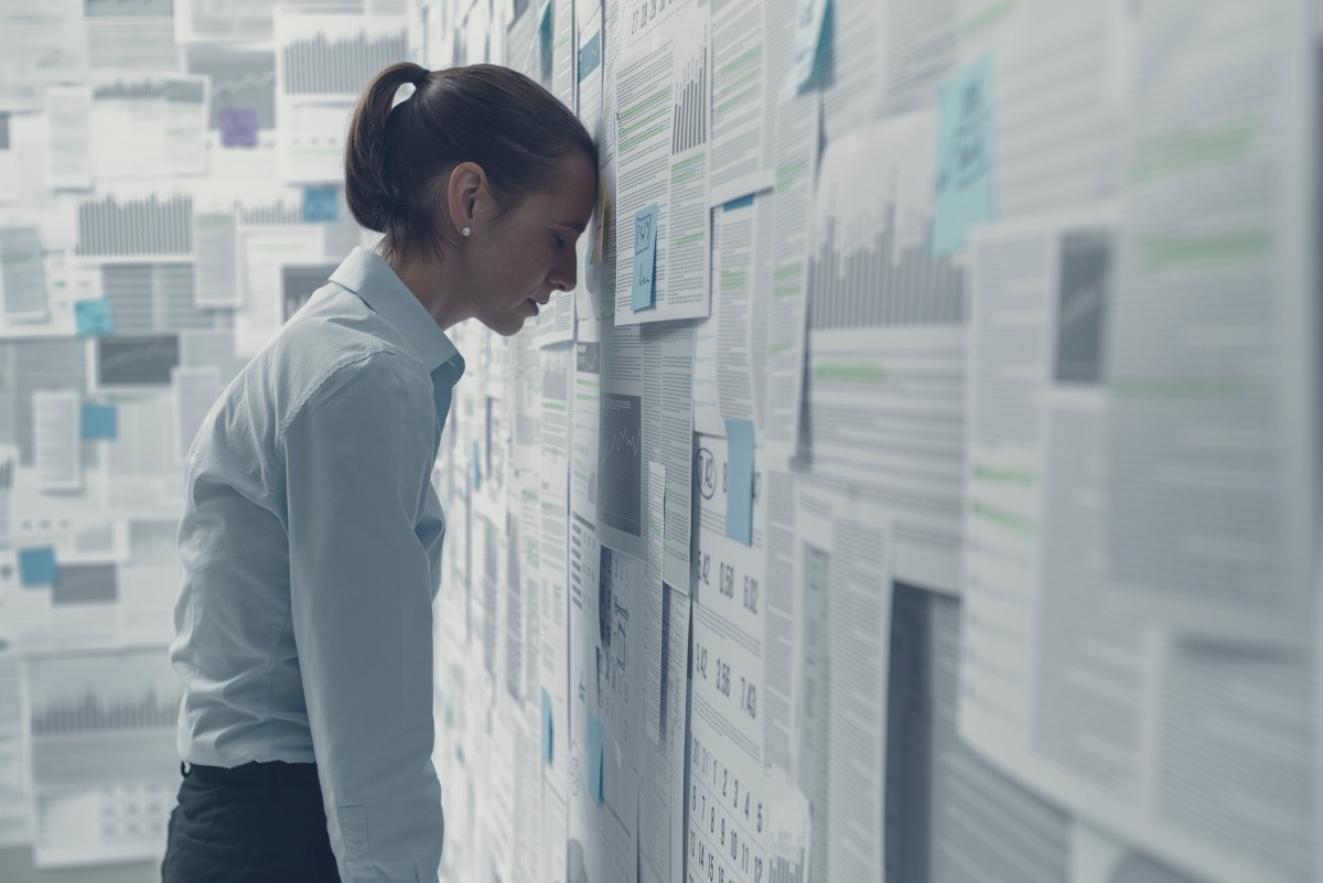 財務チャートで覆われた壁に寄りかかり、絶望感を感じている、疲れ果てて落ち込んでいるビジネスウーマン、ビジネス失敗のコンセプト