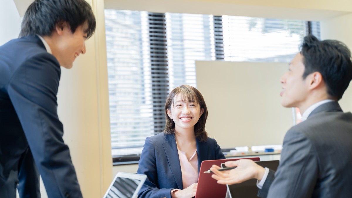 ノートパソコンで会議をする３人の男女のビジ